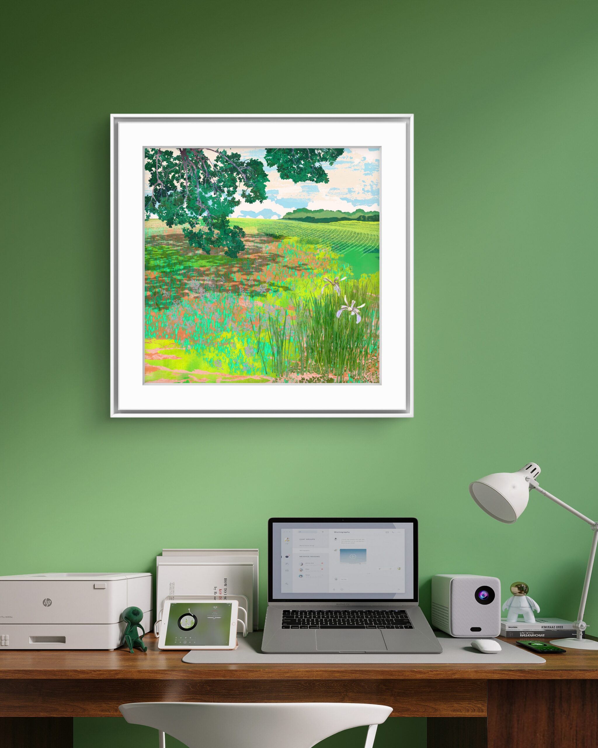 Momentary framed landscape print displayed on a green wall in a contemporary interior